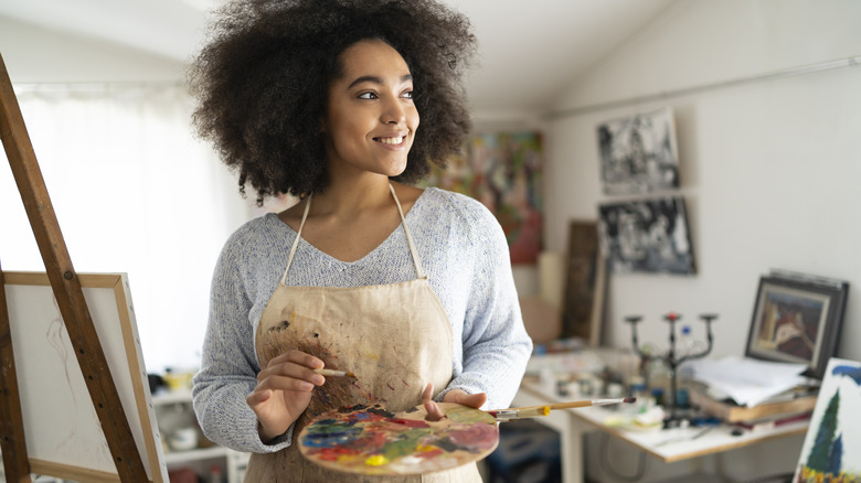 Woman painting a canvas