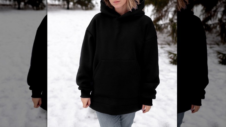 Person wearing baggy black hoodie