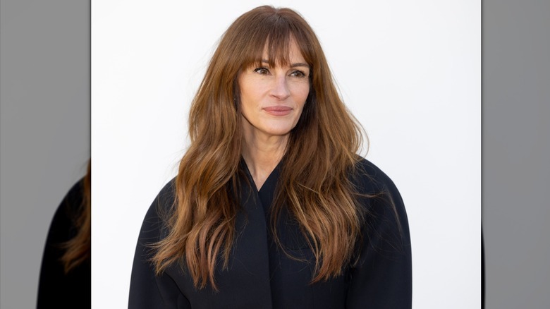 Julia Roberts with long brown waved hair and a wispy fringe.