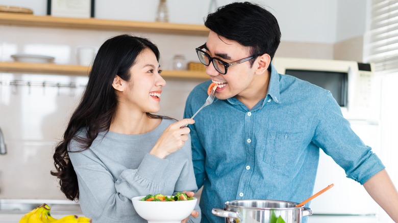 Couple eating salad together 