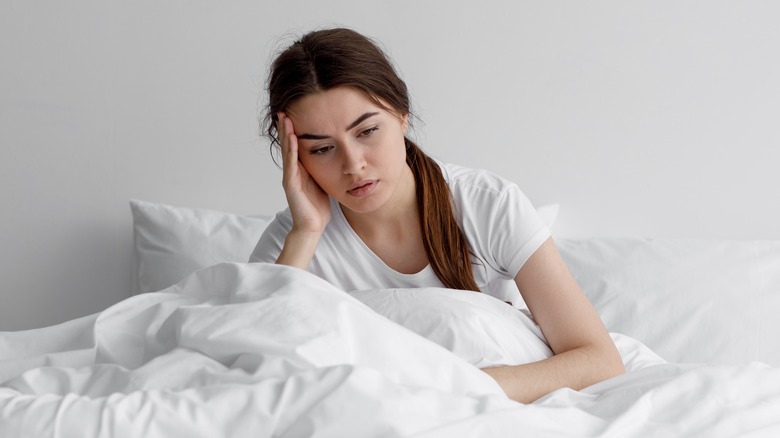 Woman sitting in bed with insomnia 