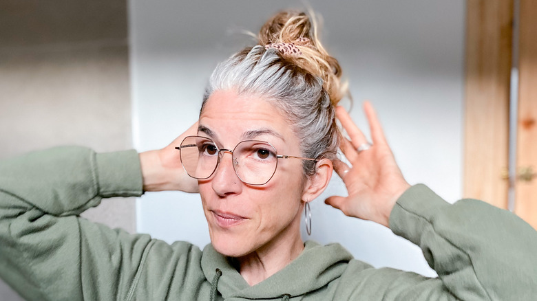 Woman touching graying hair