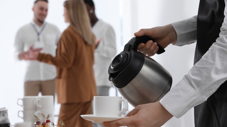 Restaurant server pouring a drink