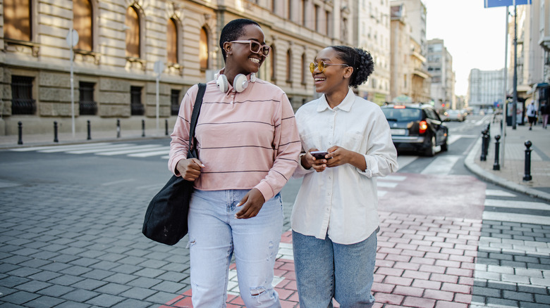 couple walking on cobblestone street 