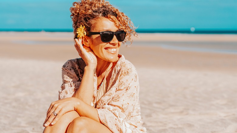 Woman on the beach enjoying the sun