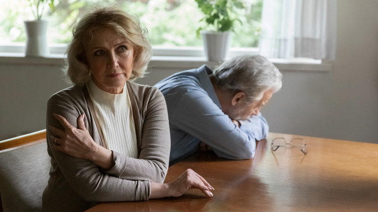 Older couple facing opposite one another