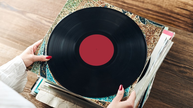 Woman organizing vinyl record collection