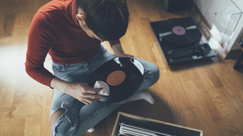 Woman cleaning vinyl record