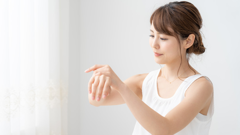 woman rubbing wrist