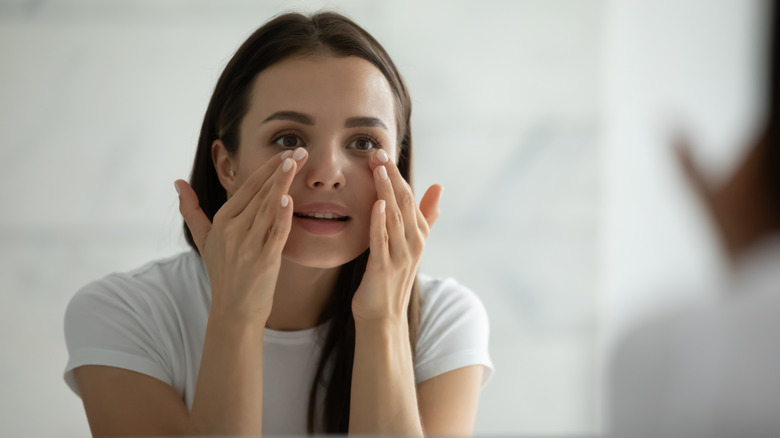 A woman moisturizing her skin