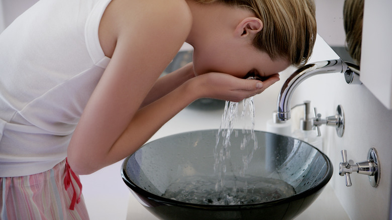 A woman washing her face