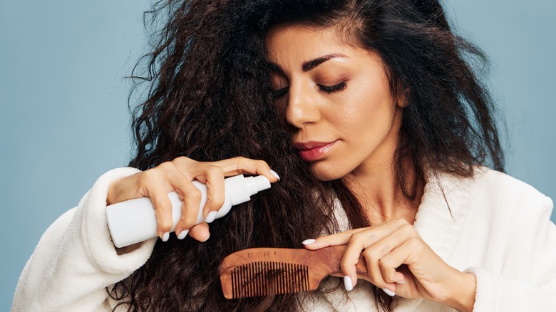 woman styling and combing hair 