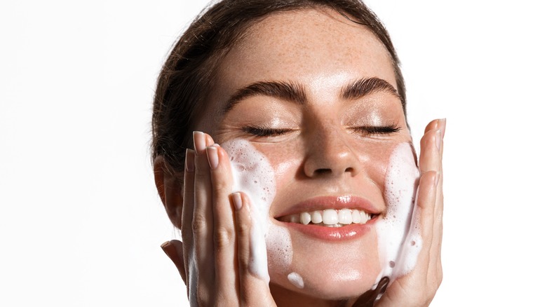 Woman applying cleanser