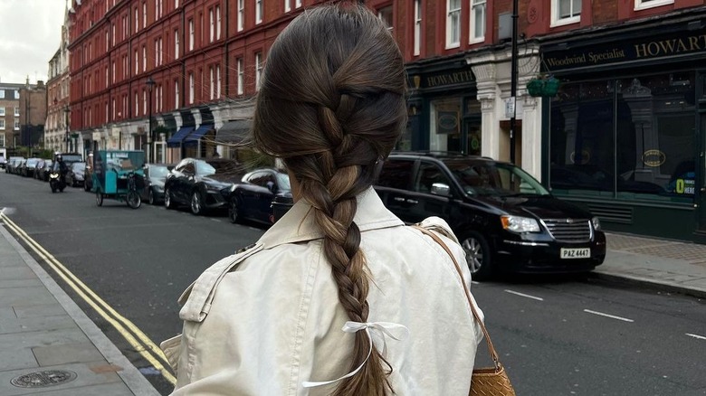 Person wearing a braid with a bow
