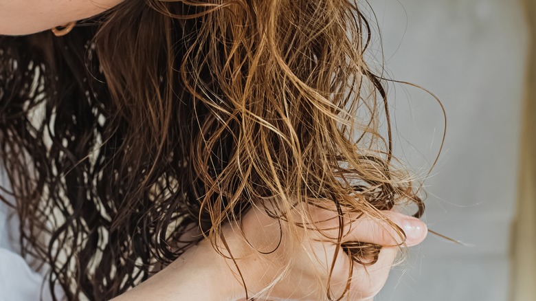 woman feeling wet hair 