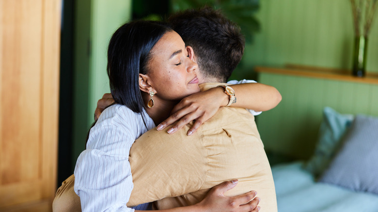 couple hugging on bed