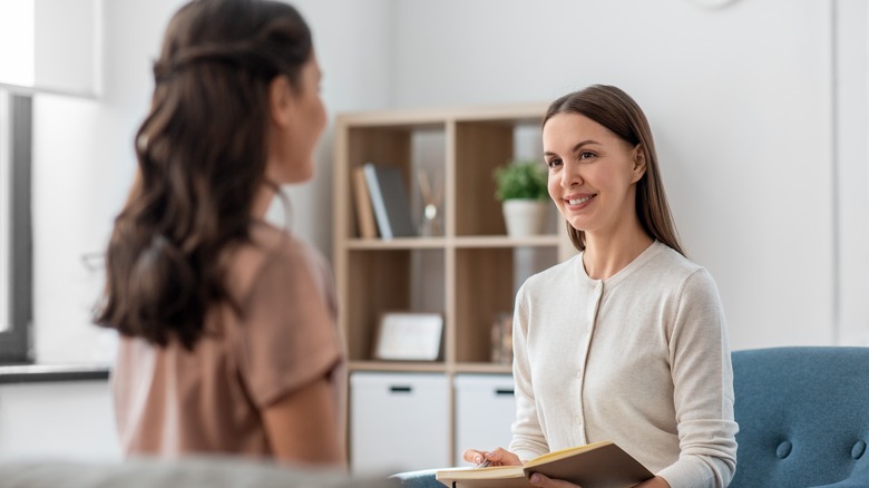 Woman talking to smiling therapist