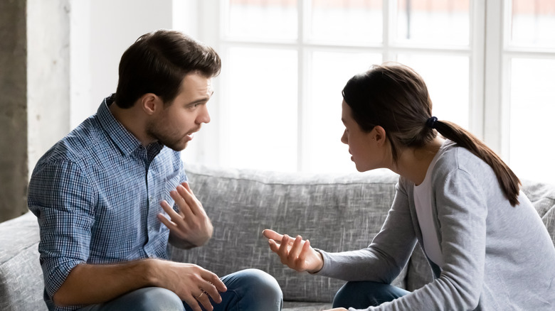 Woman looks accusingly at husband