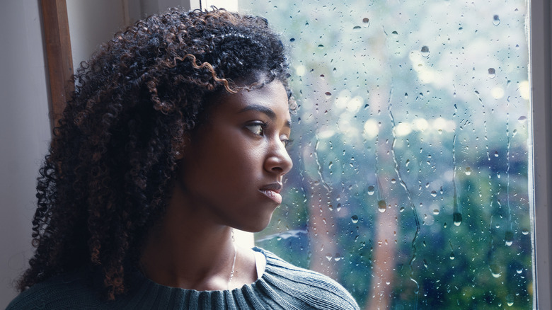 woman looking out window 