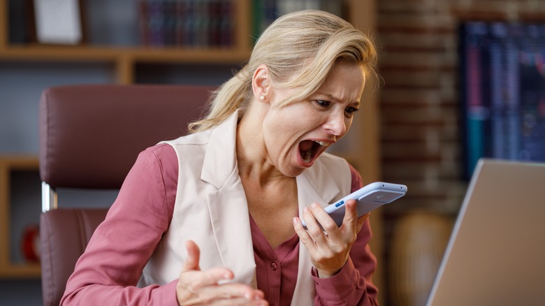 Woman shouting into smartphone