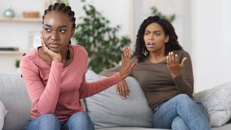 Woman turning back on upset friend