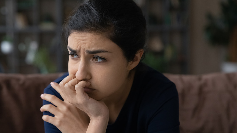 Anxious woman with furrowed brow