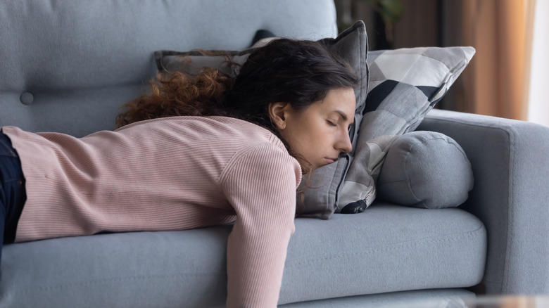 Tired woman sleeping on the couch