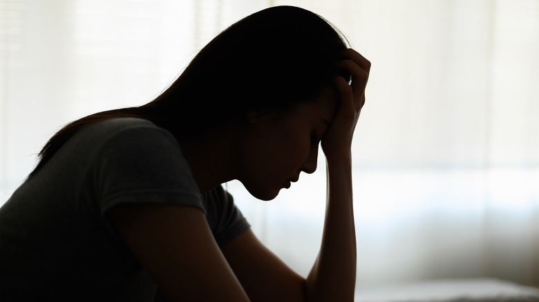 Silhouette of depressed woman