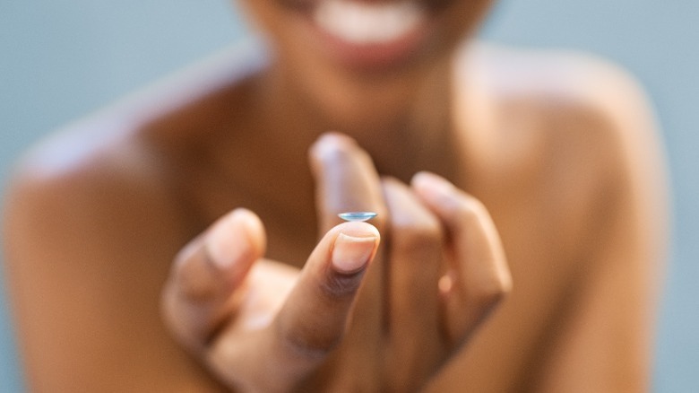 Offering contact lens on fingertip