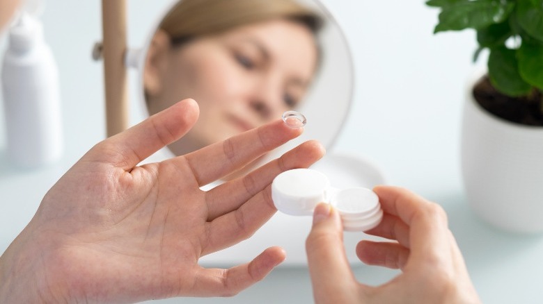 Woman holding contact lens case