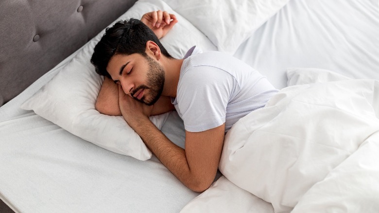 Young man sleeping in bed