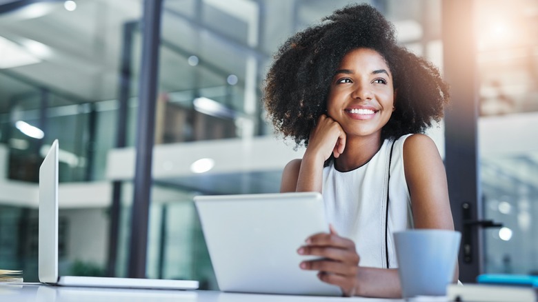 Woman smiling at laptop