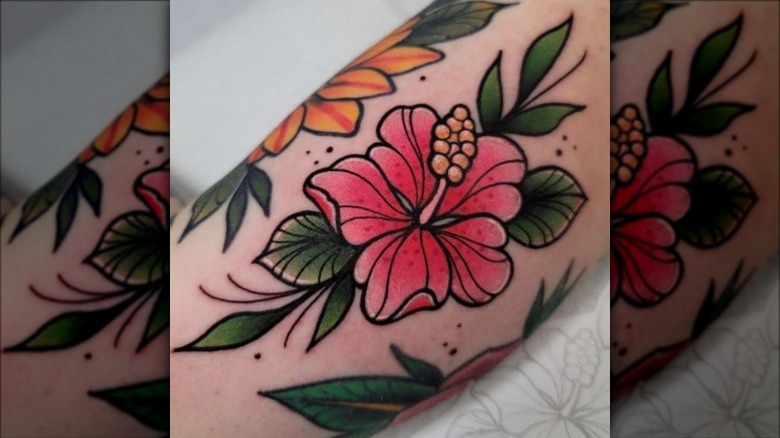 arm with colorful flower tattoo