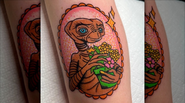 arm with colorful ET tattoo