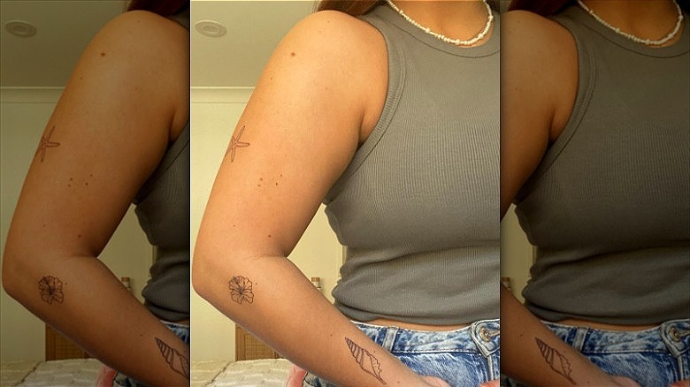 woman with stamp tattoos on arm