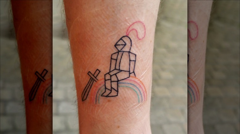ankle with knight rainbow tattoo