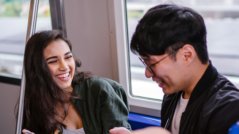 Couple laughing on train