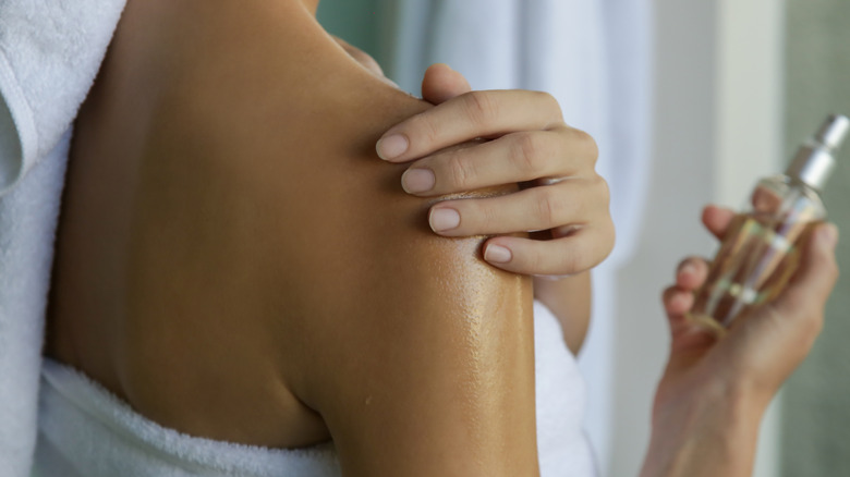 Woman applying body oil