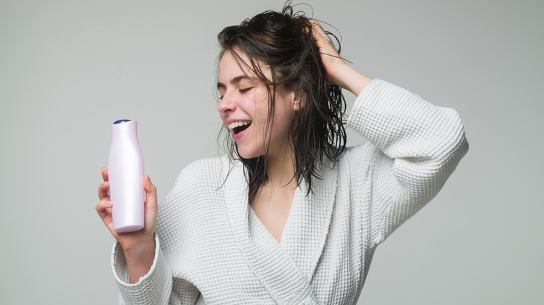 Woman holding hair care product