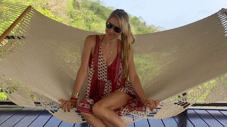 Anna Kournikova relaxing in a hammock.