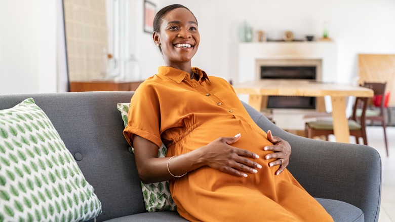 Pregnant woman sitting on a couch