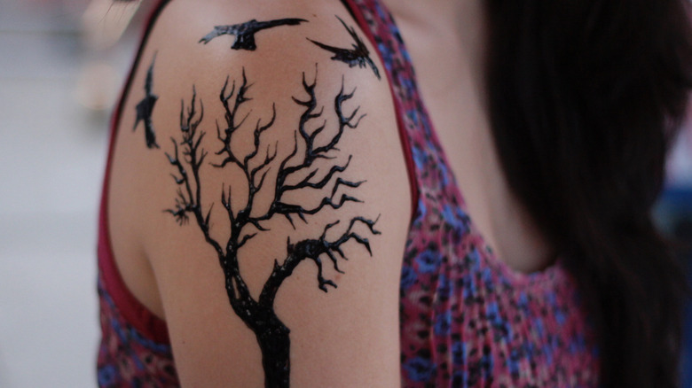 woman with tattoo of crows