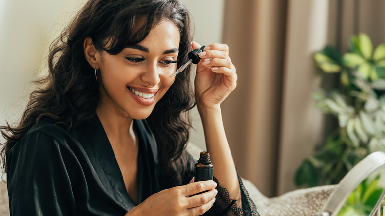 woman applying serum