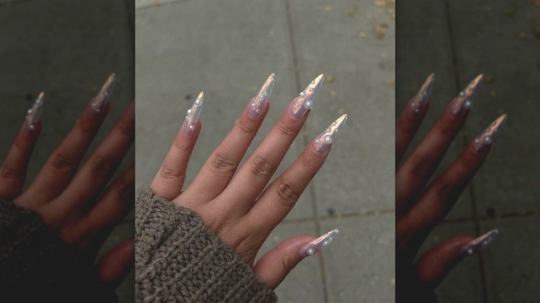 Pearl accents on a woman's nails