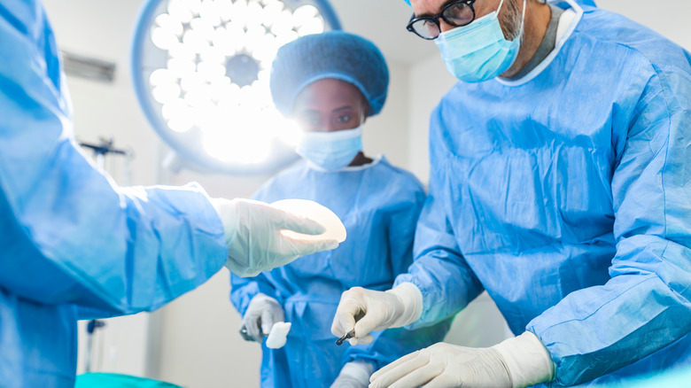 doctor taping patient's nose