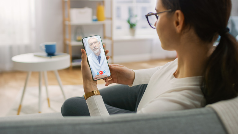 woman video calling doctor