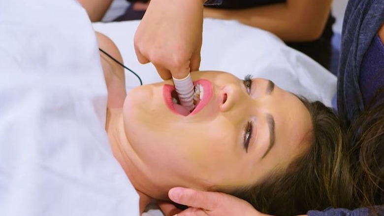 Woman receiving intraoral massage