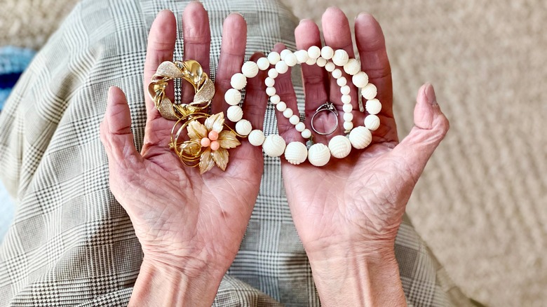 woman holding jewelry in hands