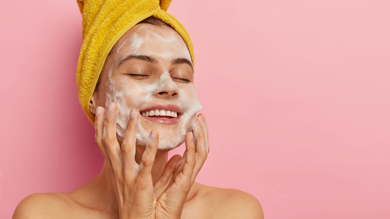 woman with cleanser on face