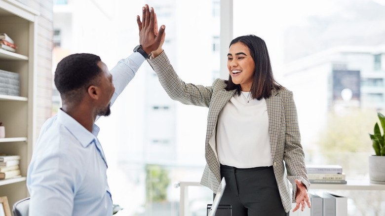 Two people high fiving